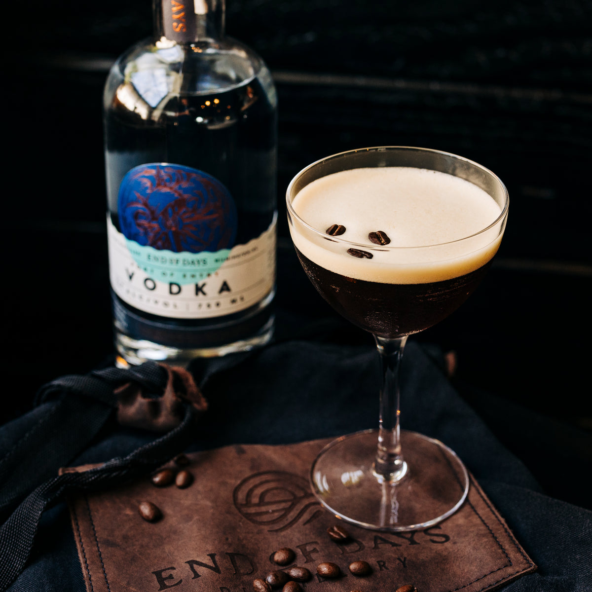 Espresso martini made with Port of Entry Vodka beside the bottle