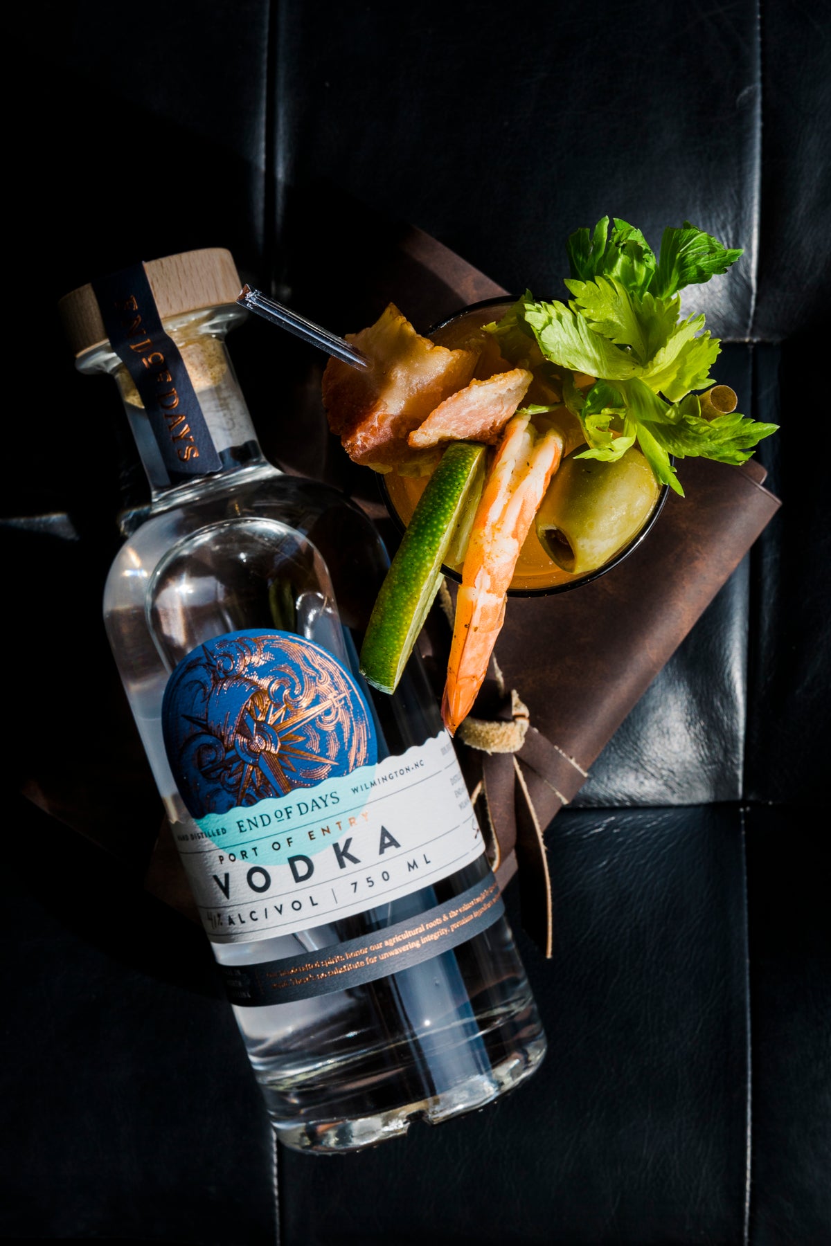 Port of Entry Vodka bottle with fresh herbs and a cocktail