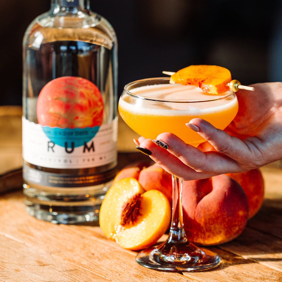 Peach rum sour made with Port of Entry Rum, garnished with a peach slice