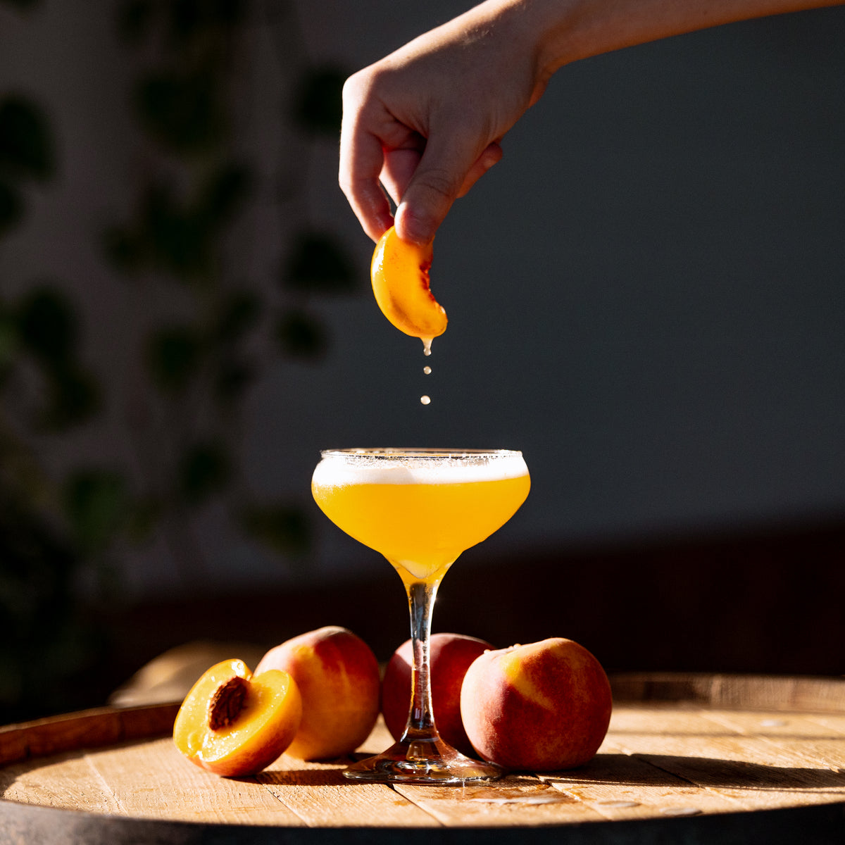 Squeezing citrus into a rum sour made with Port of Entry Rum
